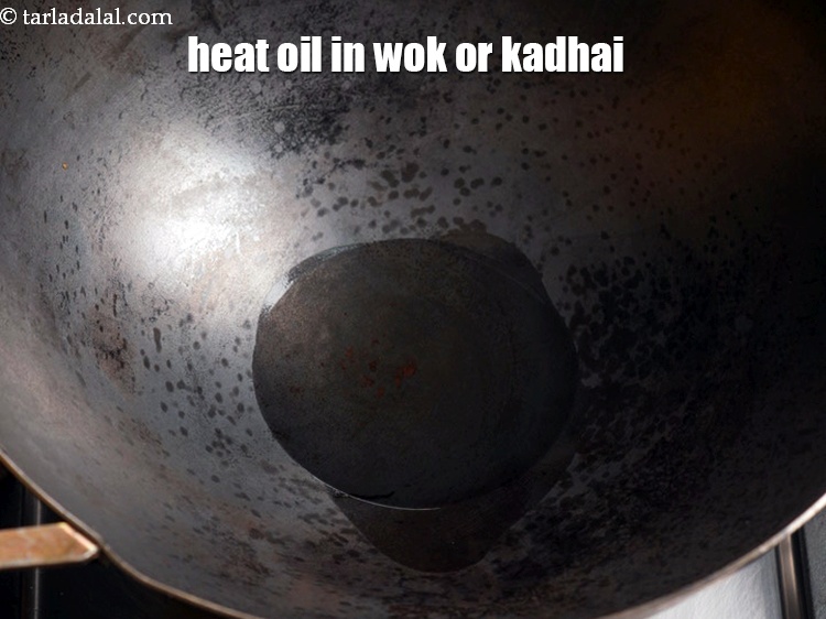 Step 3 – To make <strong>pan fried Chinese bhel</strong>, heat 2 tbsp oil in a wok/ kadhai.
