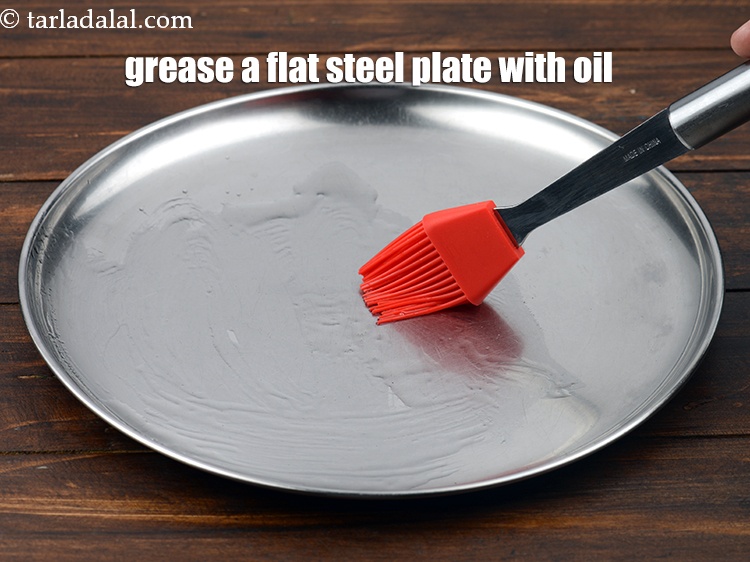 Step 3 – To make praline, grease a flat steel plate with oil using a brush and keep …