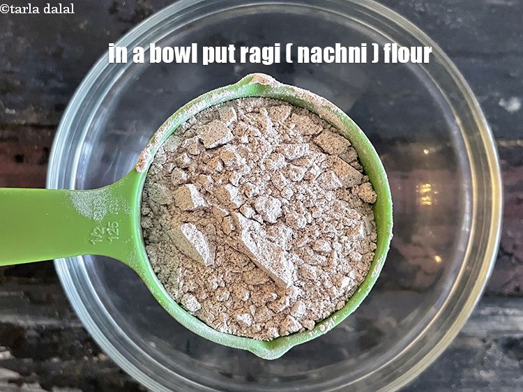 Step 3 – In a bowl put&nbsp;<meta charset="UTF-8" />1/2 cup&nbsp;<a href="glossary-ragi-flour-nachni-flour-nachni-ka-atta-red-millet-flour-1115i">ragi (nachni / red millet) flour</a>.