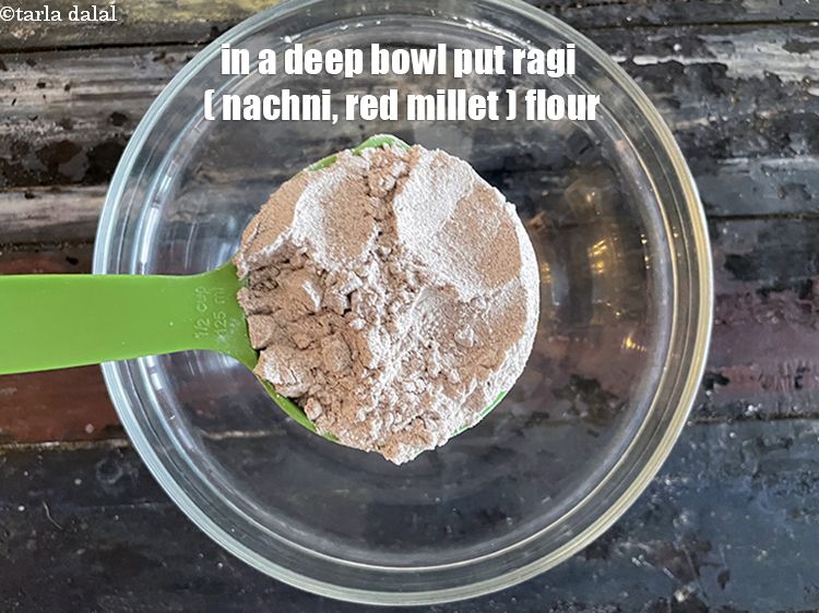 Step 4 – In a deep bowl put&nbsp;<meta charset="UTF-8" />1/2 cup&nbsp;<a href="glossary-ragi-flour-nachni-flour-nachni-ka-atta-red-millet-flour-1115i">ragi (nachni / red millet) flour</a>.
