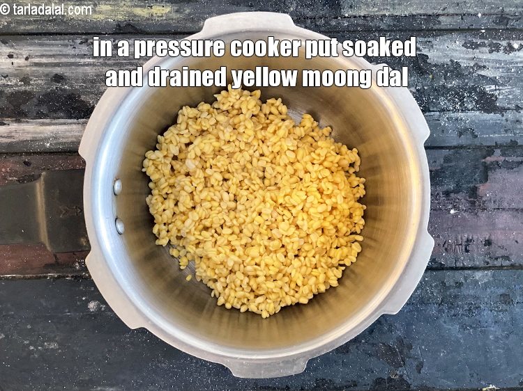 Step 16 – In a pressure cooker put the soaked and drained yellow moong dal.