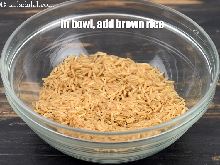 Step 4 – To make <strong>Bengali khichuri</strong>, in a deep bowl, add &frac12; cup <a href="https://www.tarladalal.com/glossary-brown-rice-1618i">brown rice</a>.