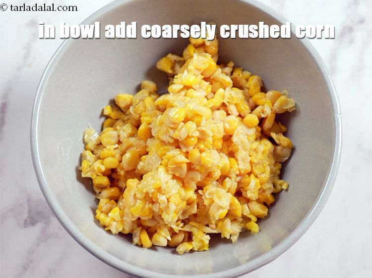 Step 4 – In a deep bowl add 1 cup boiled and coarsely <a href="https://www.tarladalal.com/glossary-crushed-sweet-corn-kernels-1605i">crushed sweet corn</a>.