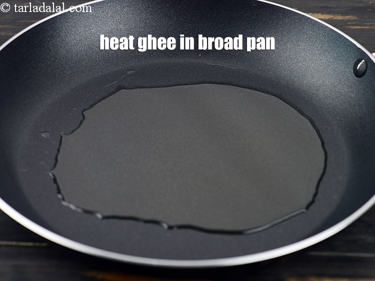 Step 3 – Heat 6 tbsp&nbsp;<a href="https://www.tarladalal.com/glossary-ghee-245i">ghee</a>&nbsp;in a broad non-stick pan.