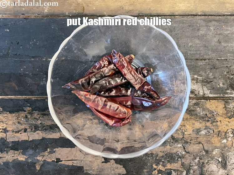 Step 21 – In a bowl put&nbsp;<meta charset="UTF-8" />8&nbsp;<a href="glossary-whole-dry-kashmiri-red-chillies-kashmiri-mirch-kashmiri-lal-mirch-332i">whole dry kashmiri red chillies</a>&nbsp;, broken into pieces.
