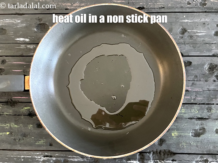 Step 3 – Heat 2 tsp oil in a broad non-stick pan.