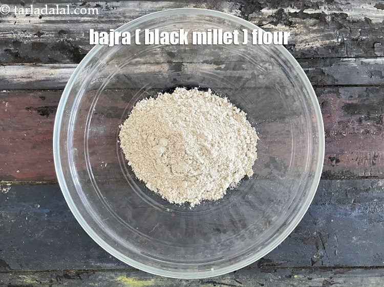 Step 6 – In a deep bowl put&nbsp;<meta charset="UTF-8" />1/2 cup&nbsp;<a href="glossary-bajra-flour-bajra-ka-atta-bajre-ka-atta-176i">bajra (black millet) flour</a>.