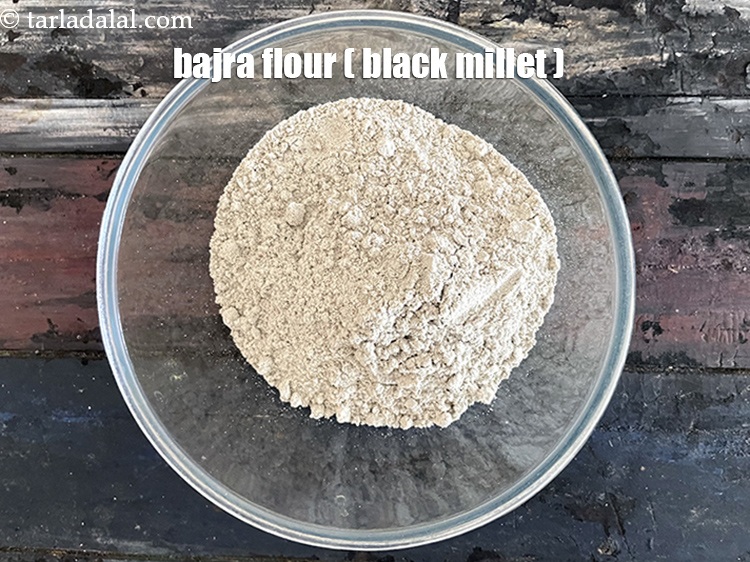 Step 3 – In a big glass bowl put&nbsp;<meta charset="UTF-8" />2 cups&nbsp;<a href="glossary-bajra-flour-bajra-ka-atta-bajre-ka-atta-176i">bajra (black millet) flour</a>.