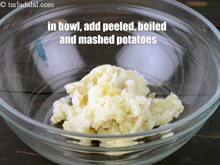 Step 3 – In a deep bowl, 1/2 cup peeled, <a href="https://www.tarladalal.com/glossary-boiled-and-mashed-potatoes-1831i">boiled and mashed potatoes</a>.