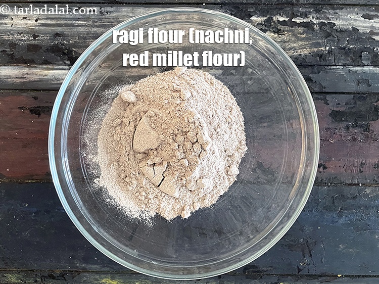 Step 5 – In a deep bowl put&nbsp;<meta charset="UTF-8" />1 cup&nbsp;<a href="glossary-ragi-flour-nachni-flour-nachni-ka-atta-red-millet-flour-1115i">ragi (nachni / red millet) flour</a>.
