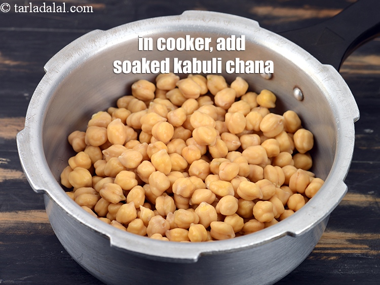 Step 4 – In a pressure cooker, add soaked and drained <a href="https://tarladalal.com/glossary-kabuli-chana-chickpeas-garbanzo-chole-chana-290i">kabuli chana (white chick peas)</a>&nbsp;.&nbsp;