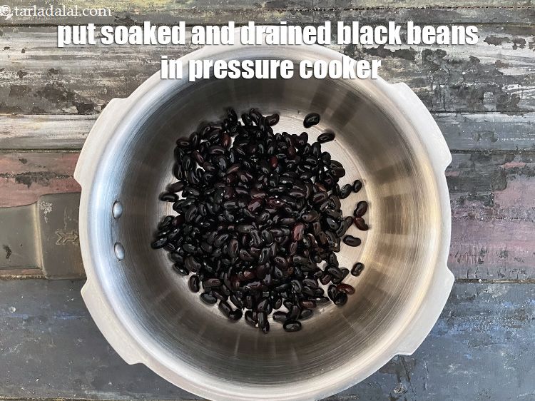 Step 10 – Put the black beans in a pressure cooker and cover with enough water.