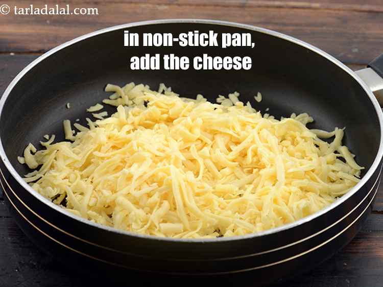 Step 3 – In a broad non-stick pan, add 2 cups&nbsp;<a href="https://www.tarladalal.com/glossary-grated-processed-cheese-868i">grated processed cheese</a>.&nbsp;