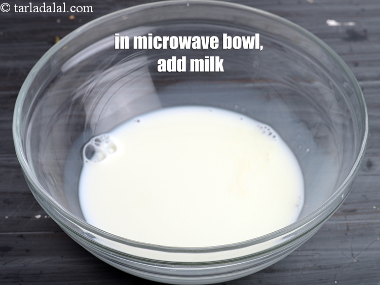 Step 3 – To make microwave sheera, in a microwave safe bowl, add &frac12; cup <a href="https://www.tarladalal.com/glossary-milk-doodh-full-cream-milk-514i">milk</a>.