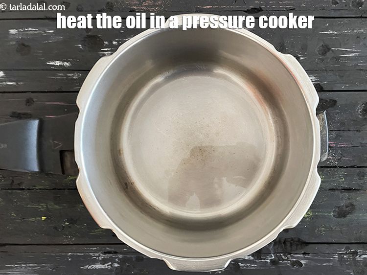 Step 6 – Heat 2 tsp oil in a pressure cooker.