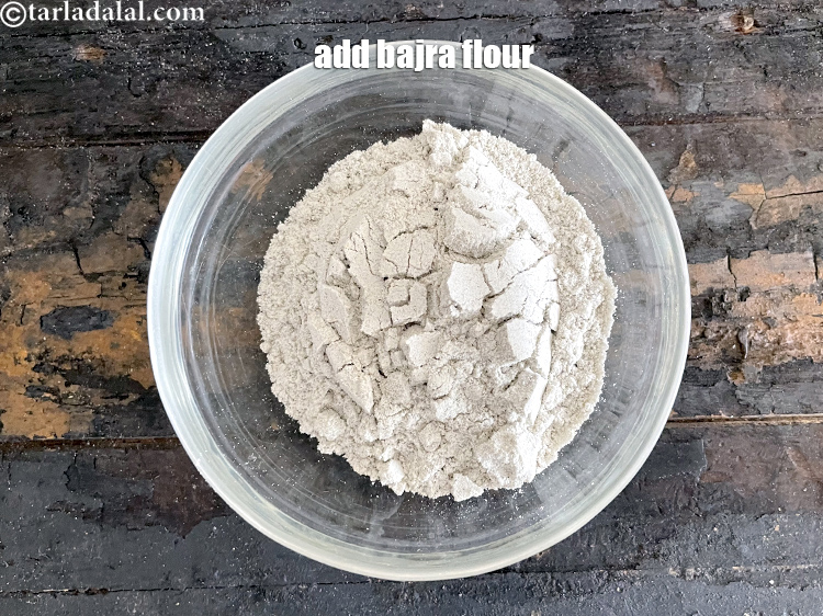 Step 14 – Add&nbsp;<meta charset="UTF-8" />1/2 cup&nbsp;<a href="glossary-bajra-flour-bajra-ka-atta-bajre-ka-atta-176i">bajra (black millet) flour</a>.