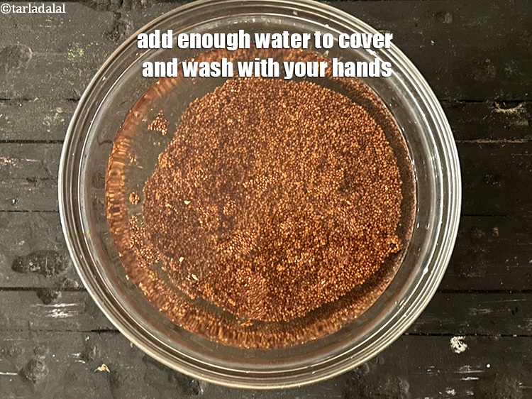 Step 4 – Add enough water to cover and wash the ragi with your hands.&nbsp;
