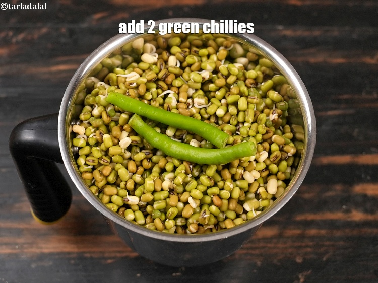 Step 12 – Add 2 <a href="https://www.tarladalal.com/glossary-green-chillies-hari-mirch-331i">green chillies</a>.