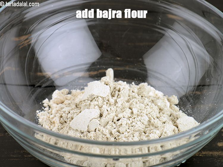 Step 4 – Add 1/4 cup <a href="https://www.tarladalal.com/glossary-bajra-flour-bajra-ka-atta-bajre-ka-atta-176i">bajra (black millet) flour</a>.
