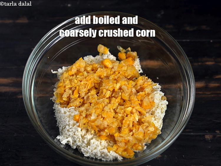 Step 4 – Add 1/2 cup <a href="https://www.tarladalal.com/glossary-boiled-and-crushed-sweet-corn-kernels-1930i">boiled and coarsely crushed sweet corn kernels</a>(makai ke dane).