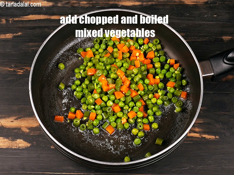 Step 4 – Add 1 cup&nbsp;<a href="https://www.tarladalal.com/glossary-chopped-and-boiled-mixed-vegetables-1884i">chopped and boiled mixed vegetables</a>.