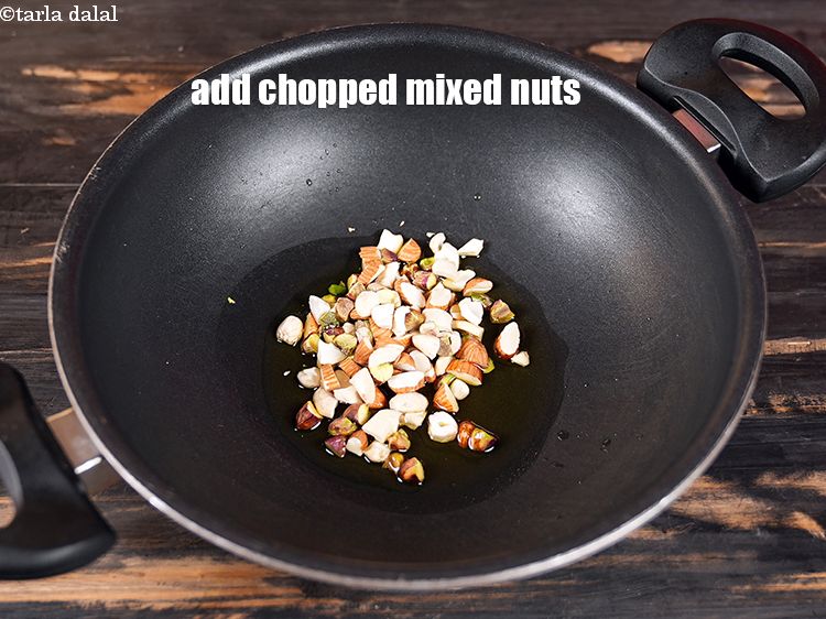 Step 4 – Add &frac14; cup <a href="https://www.tarladalal.com/glossary-chopped-mixed-nuts-928i">chopped mixed nuts</a>.