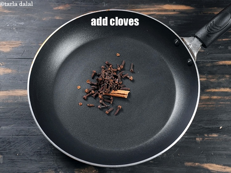 Step 4 – Add 2 tsp <a href="https://www.tarladalal.com/glossary-cloves-laung-lavang-322i">cloves (laung / lavang)</a>.
