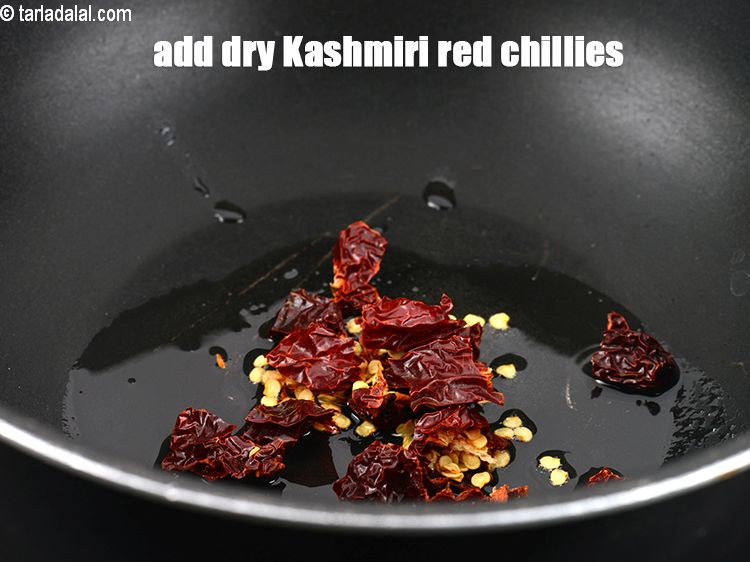 Step 23 – Add 2&nbsp;<a href="https://www.tarladalal.com/glossary-whole-dry-kashmiri-red-chillies-kashmiri-mirch-kashmiri-lal-mirch-332i">whole dry kashmiri red chillies</a>&nbsp;, broken into pieces.