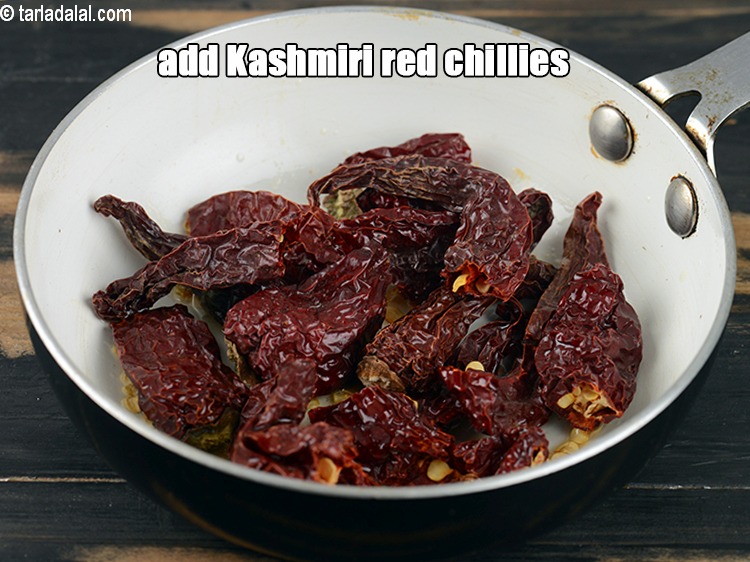 Step 5 – Add 7 to 8 <a href="https://www.tarladalal.com/glossary-whole-dry-kashmiri-red-chillies-kashmiri-mirch-kashmiri-lal-mirch-332i">whole dry kashmiri red chillies</a>, broken into pieces.