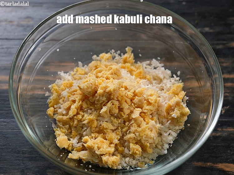 Step 4 – Add &frac12; cup boiled and mashed&nbsp;<a href="https://www.tarladalal.com/glossary-kabuli-chana-chickpeas-garbanzo-chole-chana-290i">kabuli chana (white chick peas)</a>.