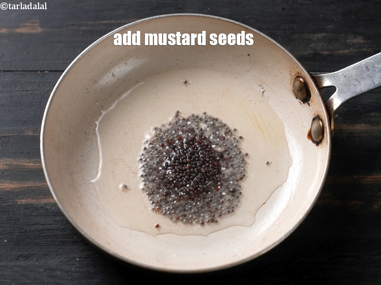 Step 4 – Add &frac12; tsp <a href="https://www.tarladalal.com/glossary-mustard-seeds-sarson-rai-sarson-ke-beej-525i">mustard seeds ( rai / sarson)</a>.