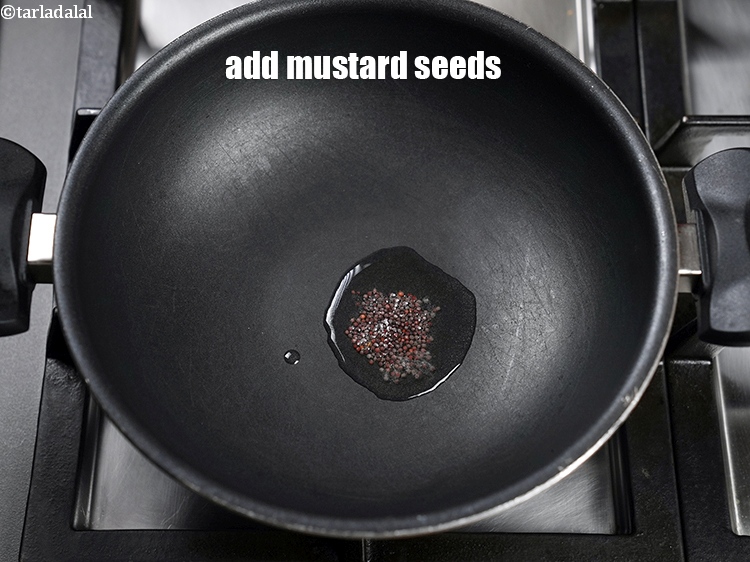 Step 4 – Add &frac12; tsp <a href="https://www.tarladalal.com/glossary-mustard-seeds-sarson-rai-sarson-ke-beej-525i">mustard seeds ( rai / sarson)</a>.&nbsp;