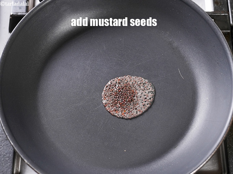 Step 4 – Add &frac12; tsp <a href="https://www.tarladalal.com/glossary-mustard-seeds-sarson-rai-sarson-ke-beej-525i">mustard seeds ( rai / sarson)</a>.&nbsp;