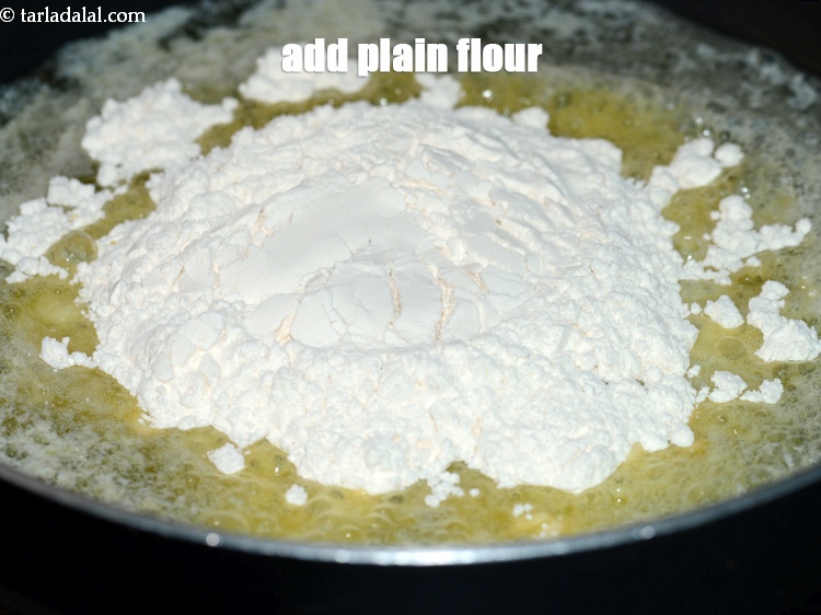Step 4 – Add &frac12; cup <a href="https://www.tarladalal.com/glossary-plain-flour-maida-188i">plain flour (maida)</a>.