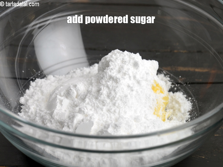Step 6 – Add &frac12; cup <a href="https://www.tarladalal.com/glossary-powdered-sugar-280i">powdered sugar</a>.