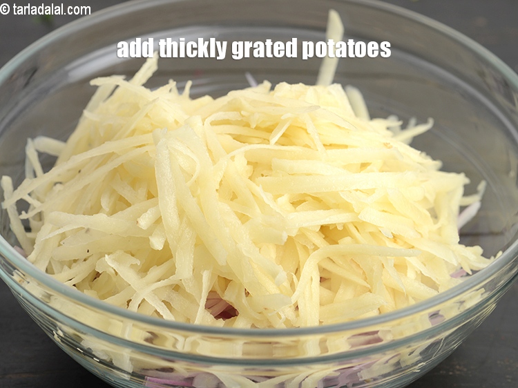 Step 4 – Add 1&frac12; cups thickly <a href="https://www.tarladalal.com/glossary-grated-potatoes-867i">grated potatoes</a>.