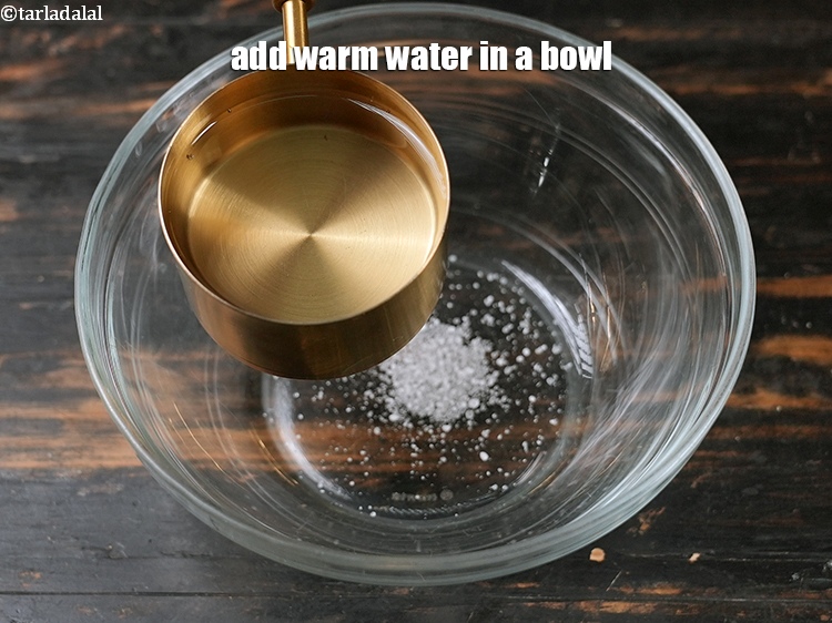 Step 4 – Add 1 1/4 cups warm water in a bowl.