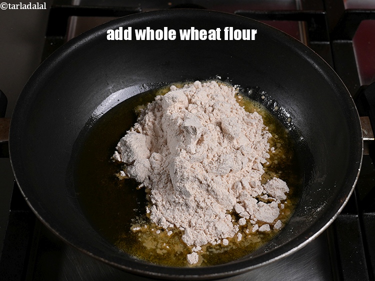 Step 4 – When the ghee melts, add whole wheat flour.