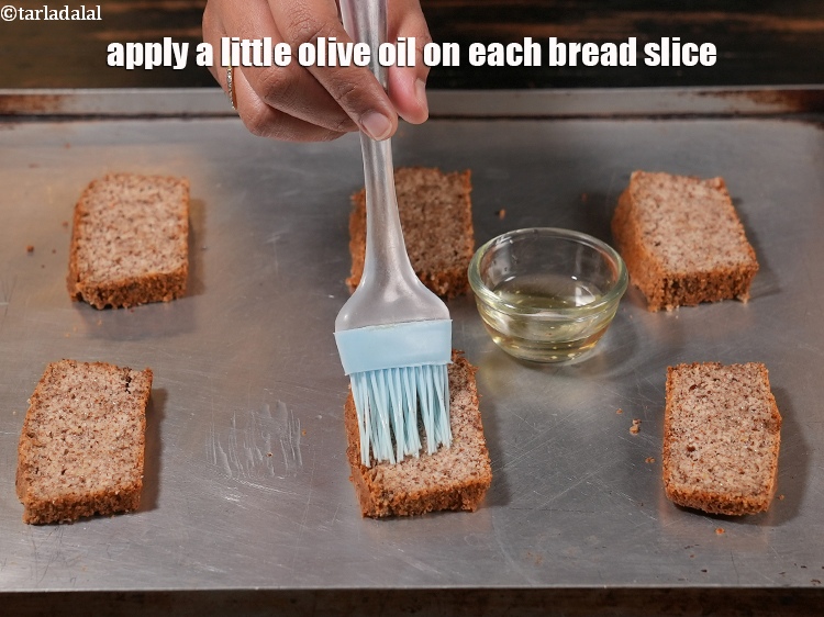 Step 6 – Apply a little <a href="https://www.tarladalal.com/glossary-olive-oil-451i">olive oil</a> on each bread slice.