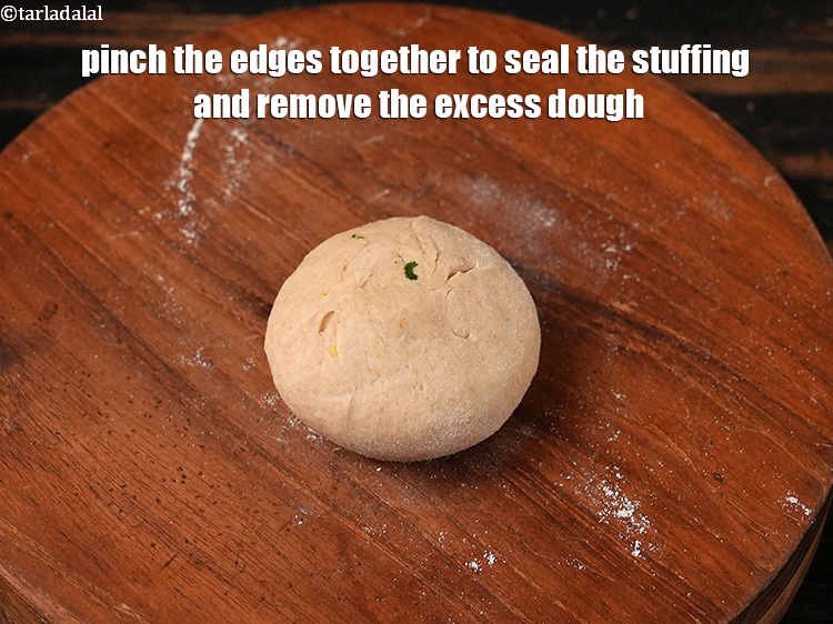 Step 34 – Pinch the edges together to seal the stuffing and remove the excess dough.