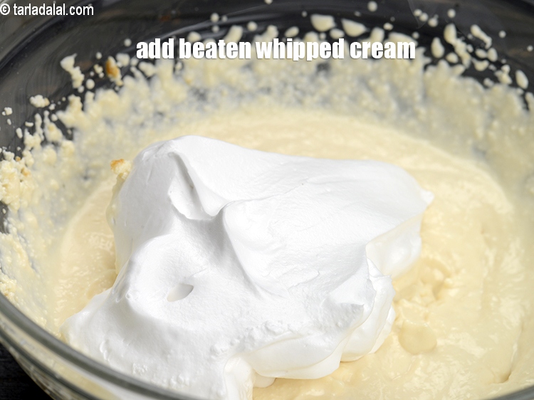 Step 27 – Add 1&frac12; cup <a href="https://www.tarladalal.com/glossary-beaten-whipped-cream-1948i">beaten whipped cream</a>.