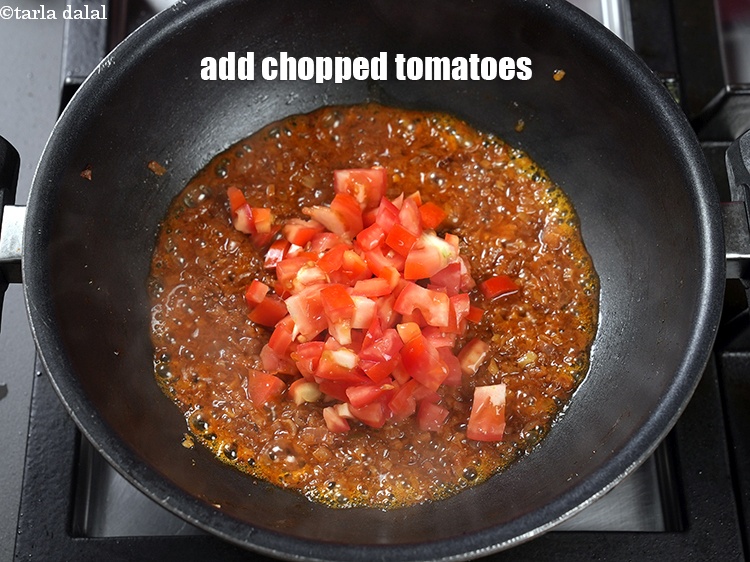Step 26 – Add &frac12; cup <a href="https://www.tarladalal.com/glossary-chopped-tomatoes-779i">chopped tomatoes</a>.