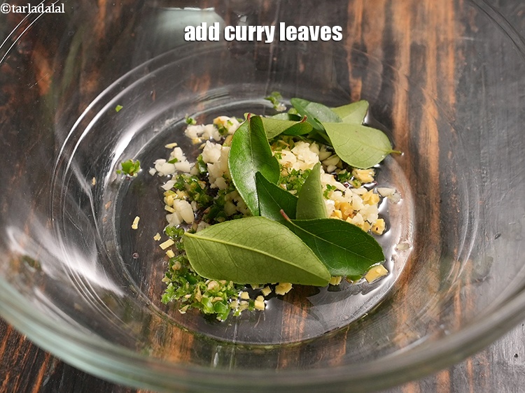 Step 22 – Add 8 to 10 <a href="https://www.tarladalal.com/glossary-curry-leaves-kadi-patta-kadipatta-388i">curry leaves (kadi patta)</a>.