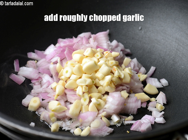 Step 23 – Add 2 tsp roughly&nbsp;<a href="https://www.tarladalal.com/glossary-chopped-garlic-790i">chopped garlic (lehsun)</a>.
