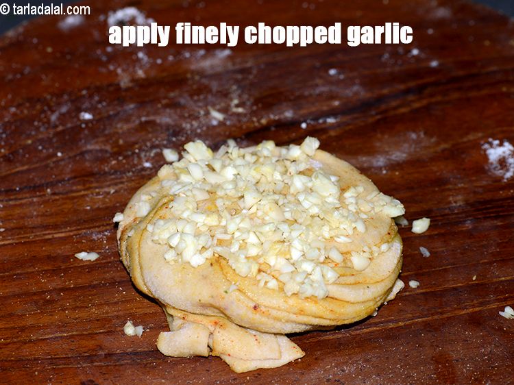 Step 22 – Apply &frac12; tbsp of finely <a href="https://www.tarladalal.com/glossary-chopped-garlic-790i">chopped garlic (lehsun)</a>.