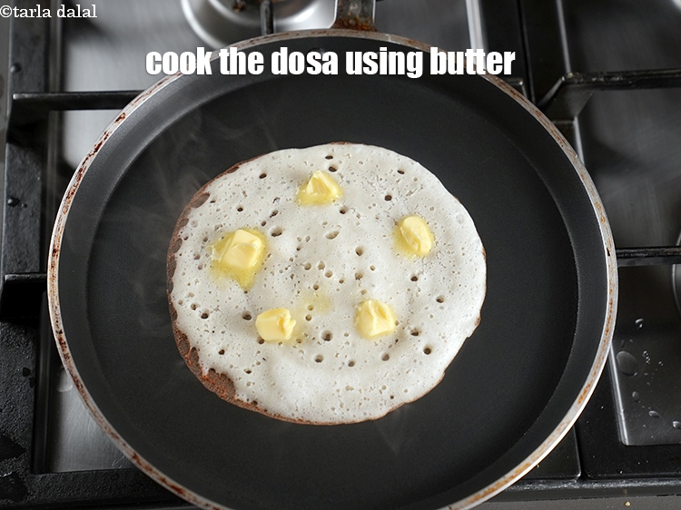 Step 22 – Cook the dosa on medium flame using 2 tsp of butter.