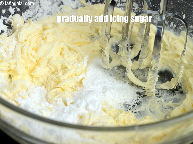 Step 24 – Gradually add &frac34; cup&nbsp;<a href="https://www.tarladalal.com/glossary-icing-sugar-confectioners-sugar-281i">icing sugar</a>.