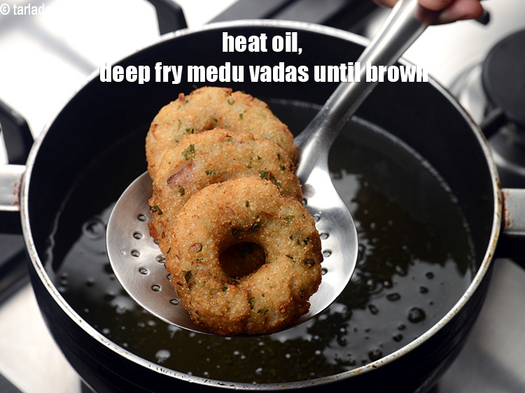 Step 22 – Heat oil in a deep pan, deep 3 to 4 medu vadas at a time …