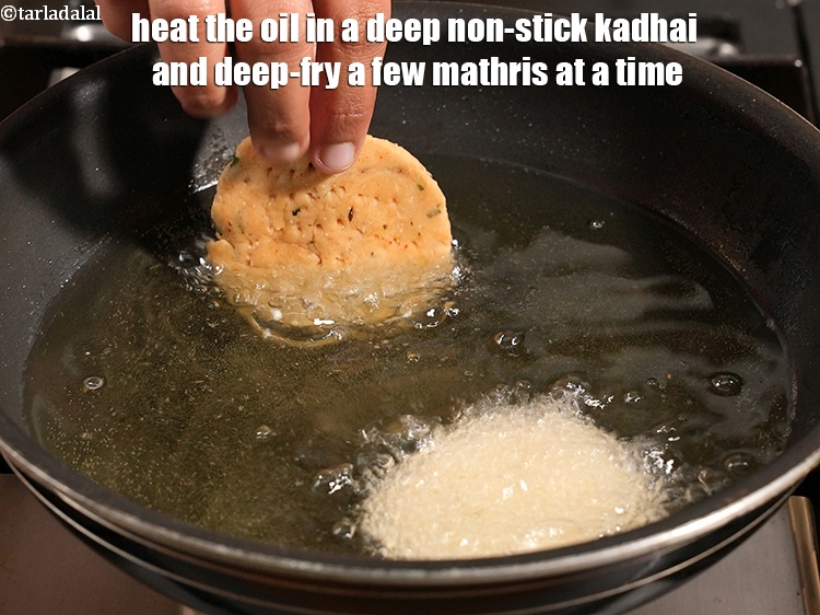 Step 22 – Heat the oil in a deep non-stick kadhai and deep-fry a few mathris at a …