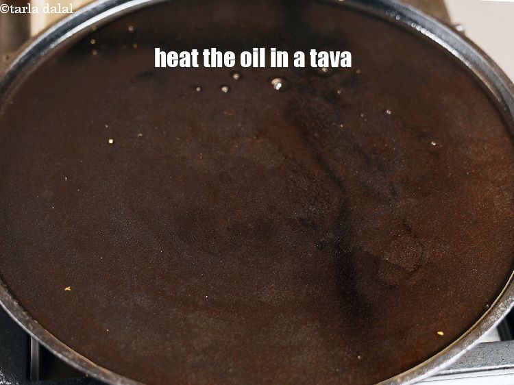Step 22 – Heat the oil in a non-stick tava (griddle).